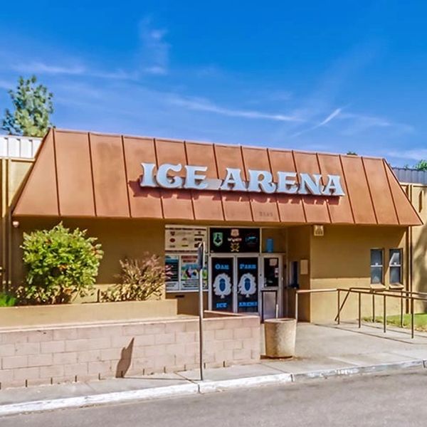 A wide-angle view showcasing the front entrance and façade of the Oak Park Ice Rink.