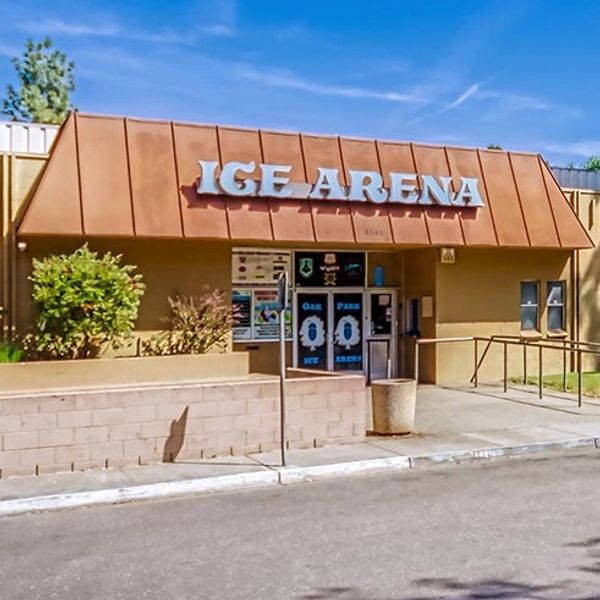 A wide-angle view showcasing the front entrance and façade of the Oak Park Ice Rink.