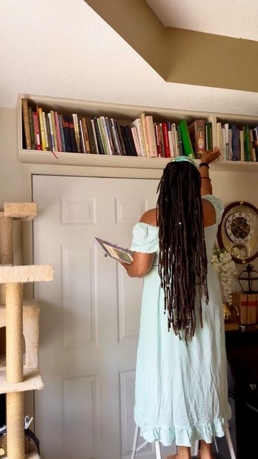 grabbing book from bookshelf 