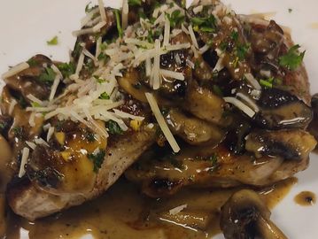 Two Pork chop bocatto with mushrooms, madeira sauce and one side of your choice