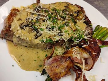 12 oz ribeye, mushrooms sauté with madeira sauce, and one side of your choice.