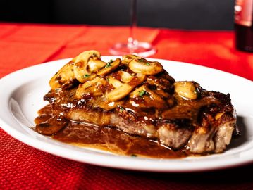 12 oz NY Strip, sauté mushrooms with madeira sauce, and one side your choice.