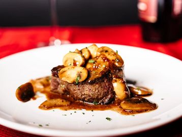 6 oz filet, mushrooms, madeira sauce, and two sides of your choice.