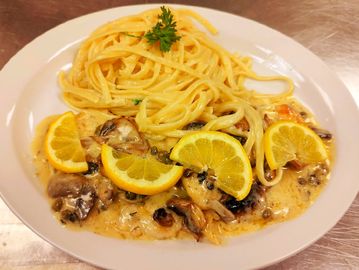 Pounded chicken, spaghetti, lemon butter sauce, capers, garlic, mushrooms and half lemon moon style.