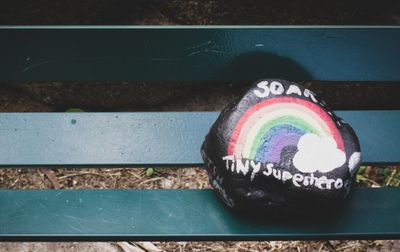 Black Painted rock with rainbow and text "SOAR" and "TINY SUPERHEROES"
KINDNESS ROCK MISSION 2020