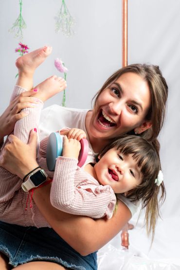 Happy woman holding a smiling child.