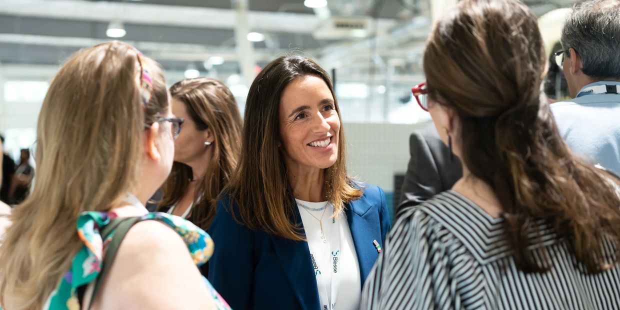 Group of women engaging in a lively conversation at an event.