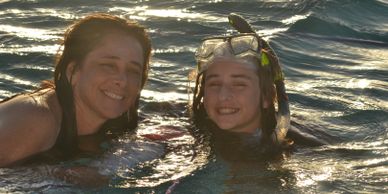 Mother and child swimming . boat charter are for the family 