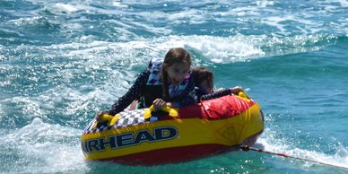 girls tubing. great Water sport include in our charter rental