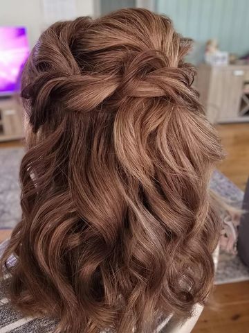 Elegant half-up braided hairstyle with soft curls.
