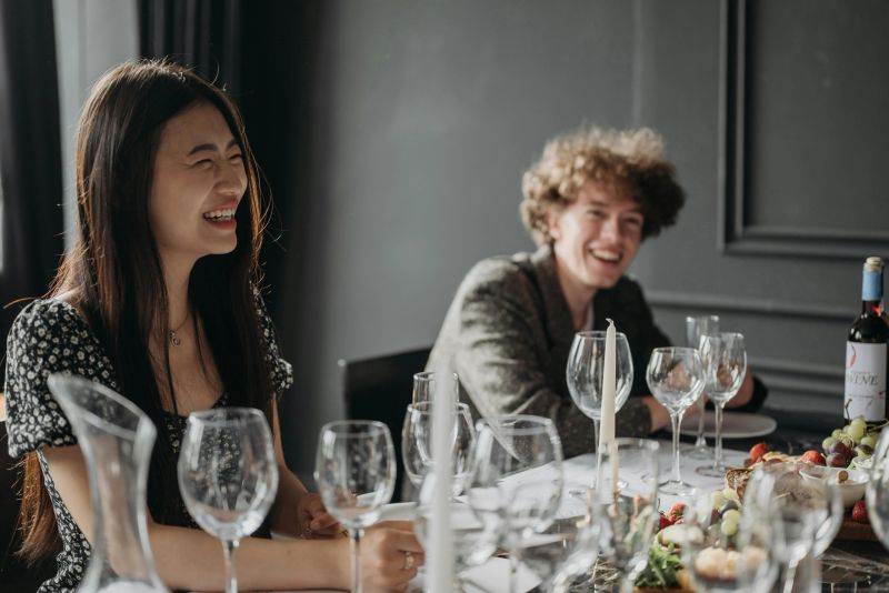 Two people at dining table smiling