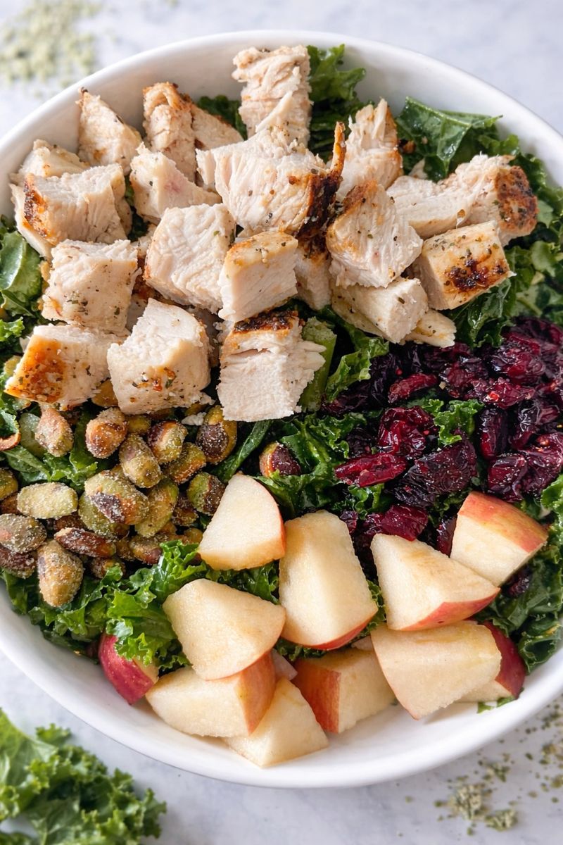 Salad bowl with chicken, apples, pistachios and craisins