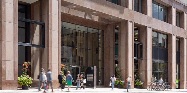 Oblique street view of the all-glass entrance and existing colonnade with canopy skylight.
