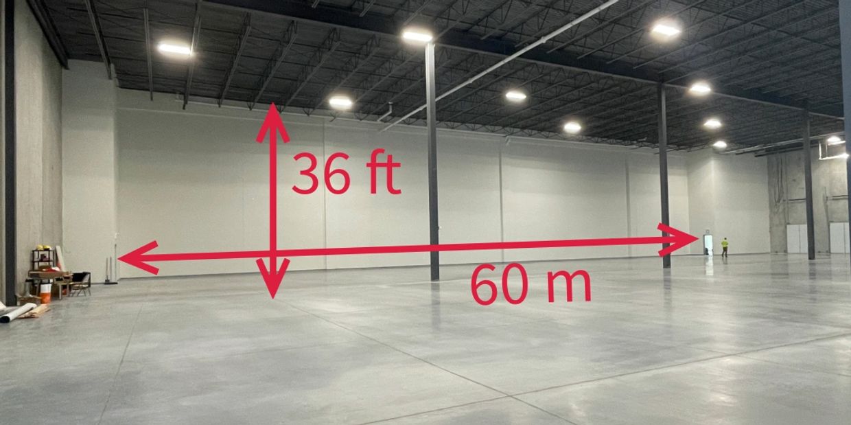 Photo of a warehouse interior showing a 36-ft high and 60 m long demising wall with exit vestibules