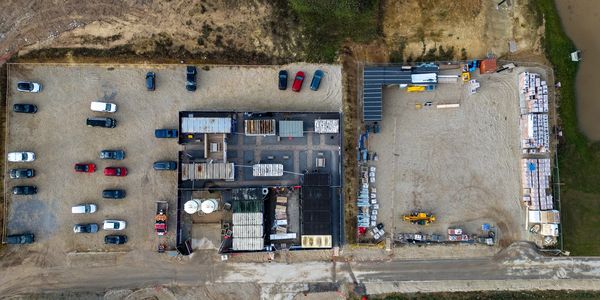 Aerial photo of an outdoor storage site surrounded by vacant land
