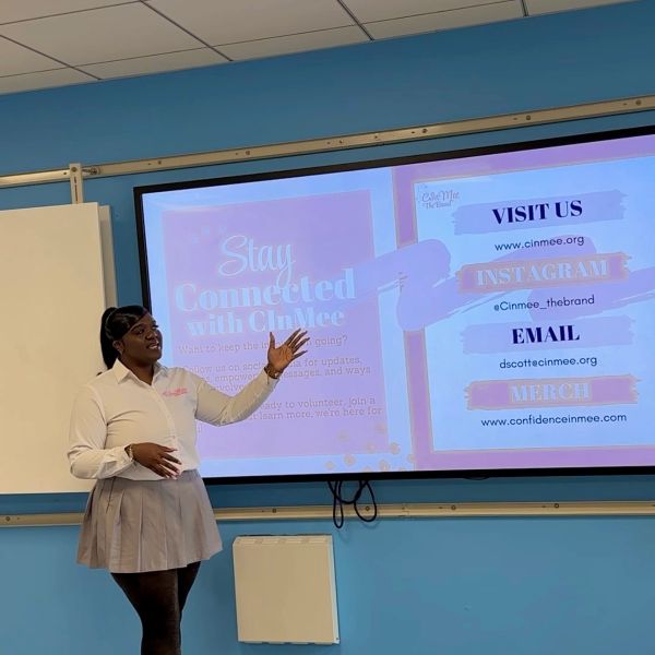 Woman presenting information on staying connected with CinMee.