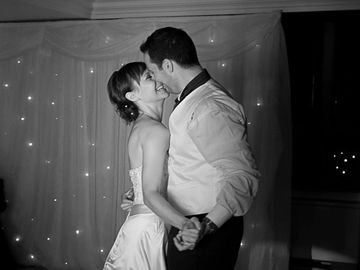 Couple sharing a romantic dance at a formal event.