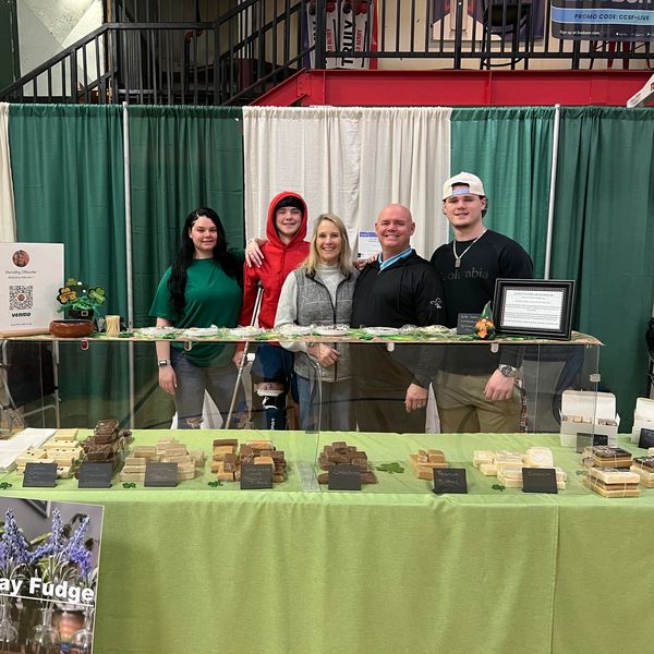 Group of five people at a fudge stand.
