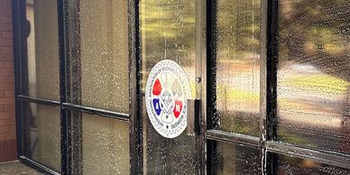 Glass door and windows being cleaned with soap and water.
