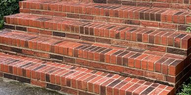Comparison of dirty and clean brick stairs surrounded by greenery.