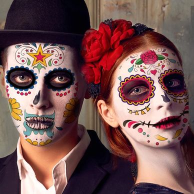 Couple with vibrant Day of the Dead face paint and costumes.