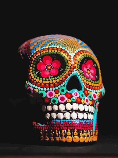 Colorful decorated skull with floral patterns on black background.
