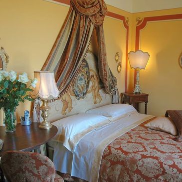 Elegant bedroom with ornate bed and classic decor.