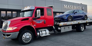 Gates Towing a Maserati on a flatbed truck
