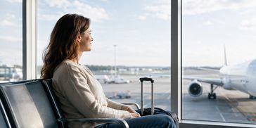 Calm traveller watching an aircraft, representing confidence with flying.