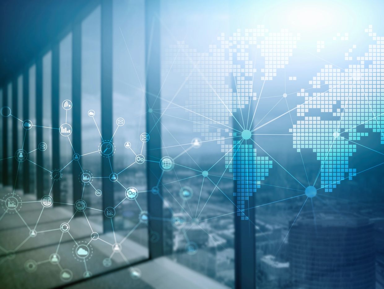 Digital network connections overlaying a cityscape through large windows.