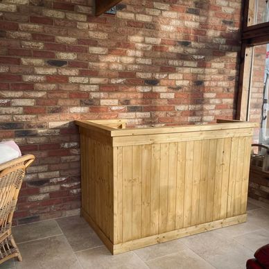 a bar designed for indoor & outdoor use. panelled front with a serving & preparation shelf.