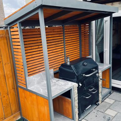 A BBQ storage shelter with preparation work space. 