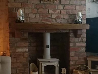 a solid oak mantle beam with corbels