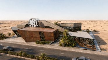 Modern desert building with angular design and large circular window.