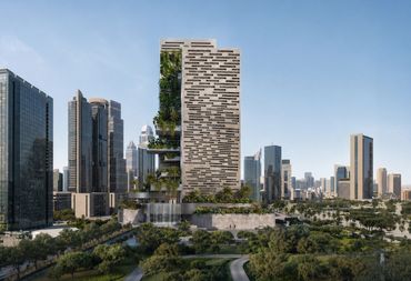 Modern high-rise building with vertical greenery and waterfalls in a cityscape.
