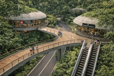 Futuristic elevated walkways connecting round buildings in a lush forest.