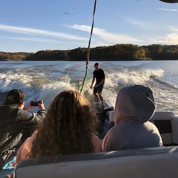 A group of wakesurfers watching from the Nautique G23