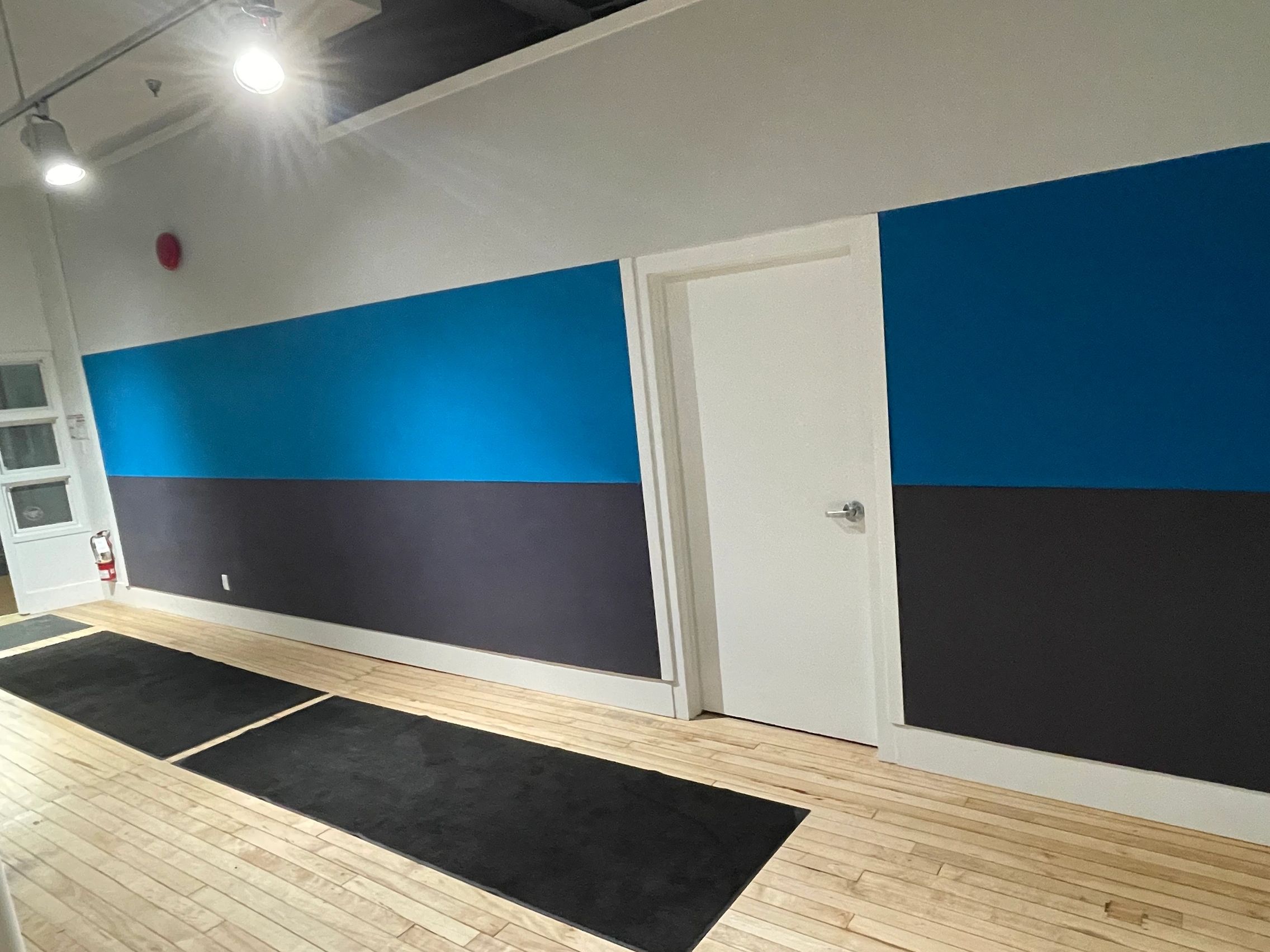An empty room with blue and black paint job