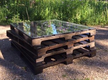 Unique pallet coffee table with glass top.