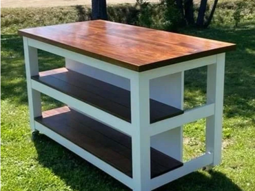 Kitchen island created with white painted wood and walnut top and shelves.