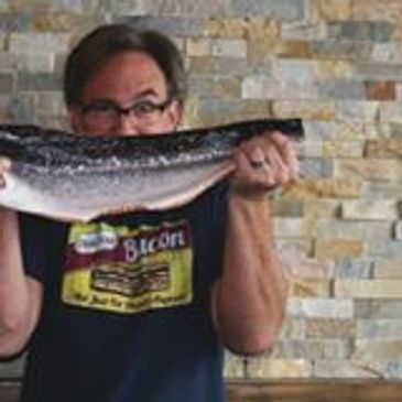 Chef-Owner holding fresh salmon maniacally.