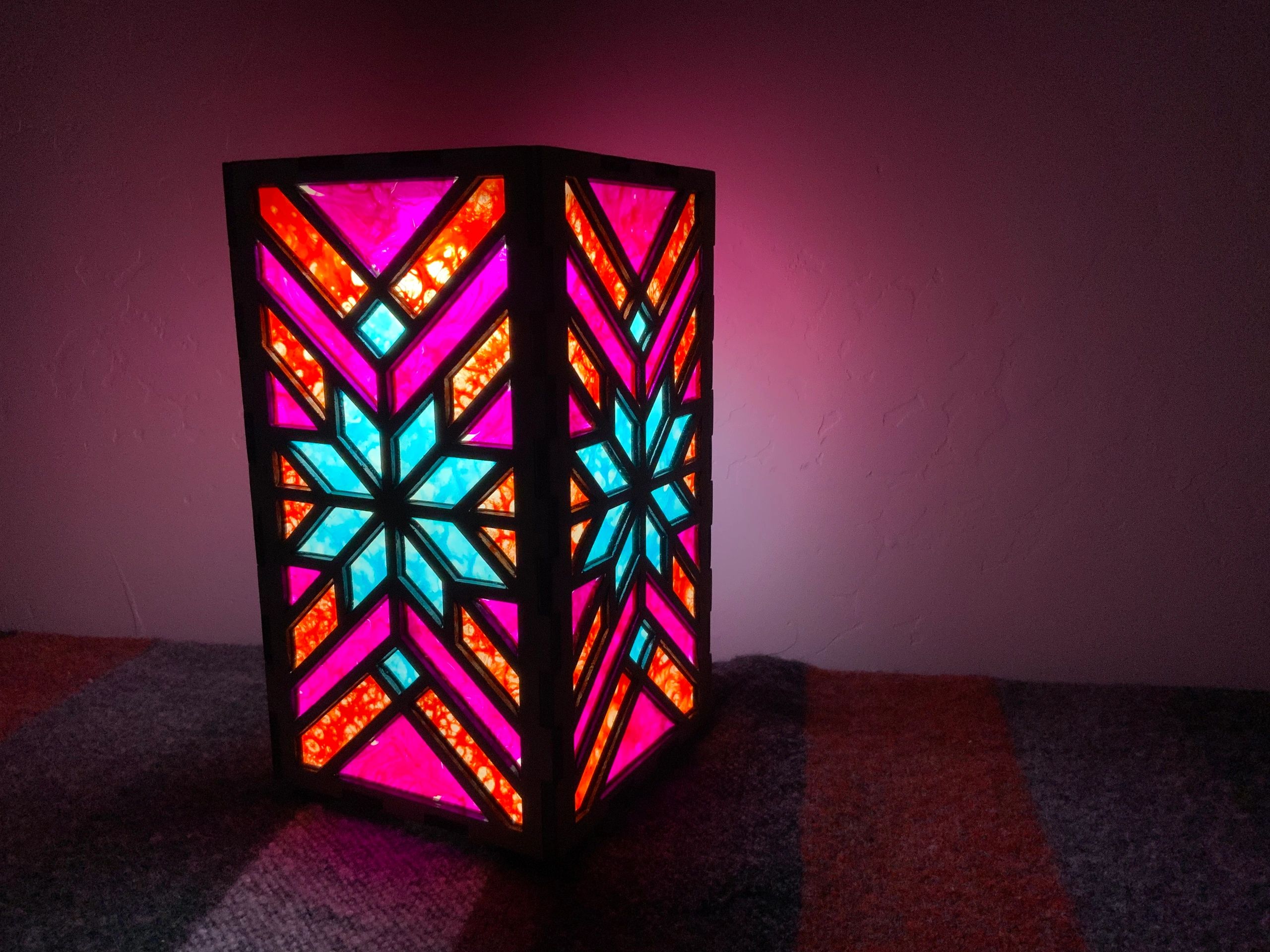 Home accent lantern made from laser cut birch plywood with a tinted epoxy resin inlay. Original Desi