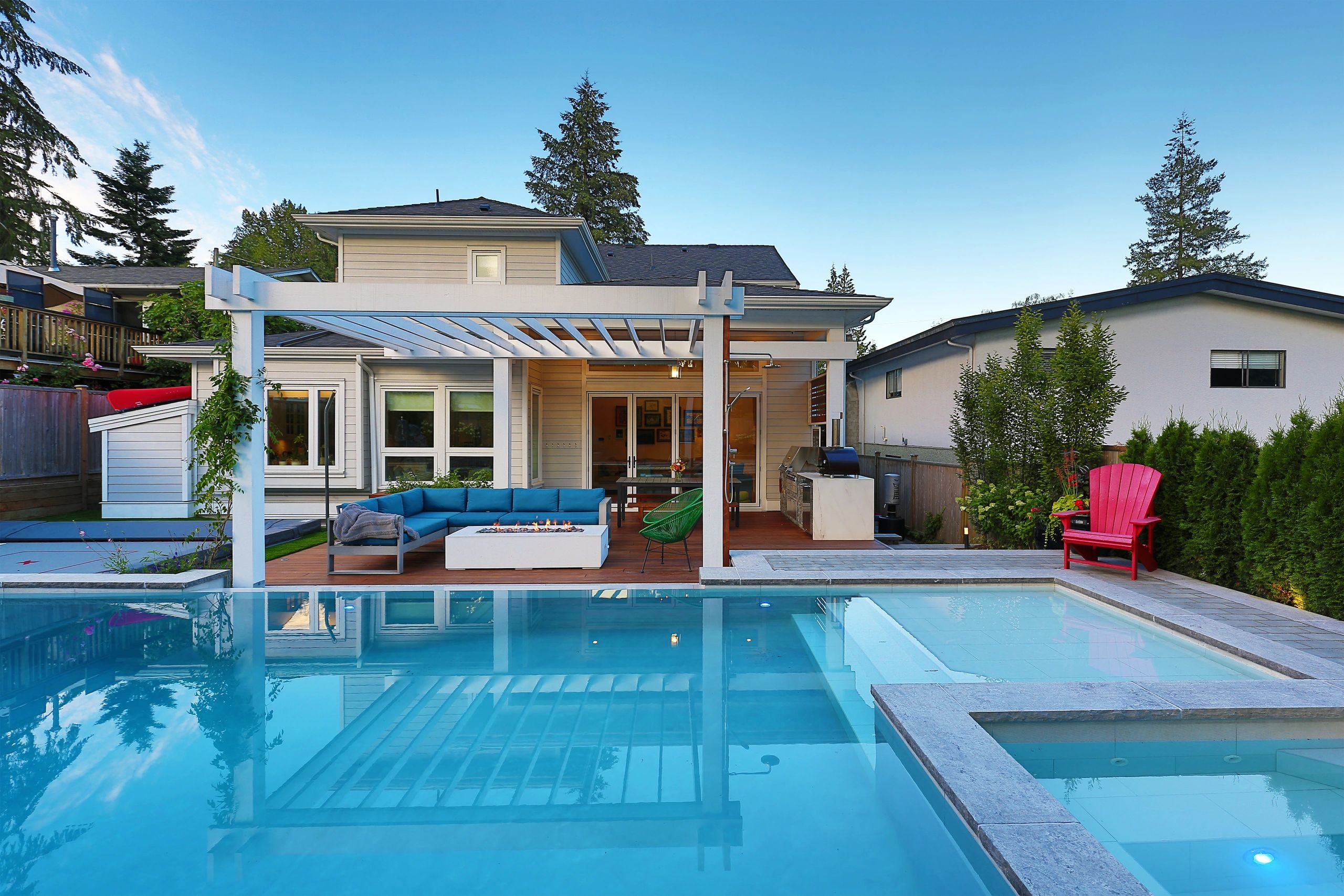 Landscape design in North Vancouver with pool, pergola, and outdoor fire pit.