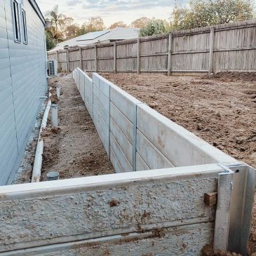 Newly built retaining wall beside a house.
