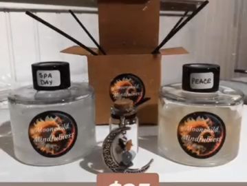 Two scented candles labeled 'Spa Day' and 'Peace' with a moon and witch charm.
