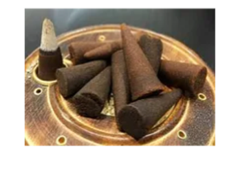 Close-up of incense cones arranged on a decorative holder.