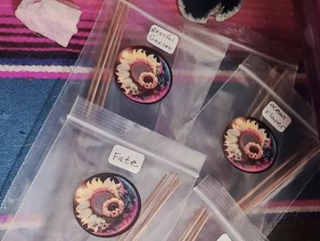Incense sticks with labeled bags and decorative round holders.