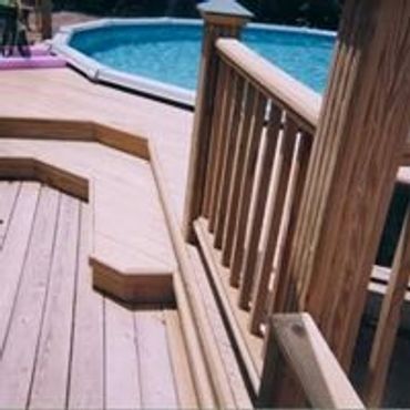 New Pool deck surrounding a 23' above-ground pool with a Greco-Roman inset Hot tub.