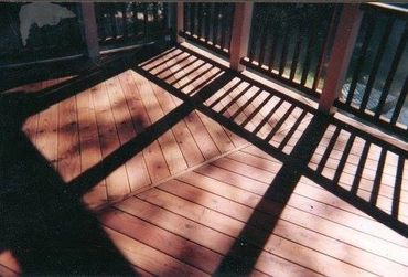 Custom-built Redwood deck, rails, and Gable posts Herringbone style pattern withPainted white Pine