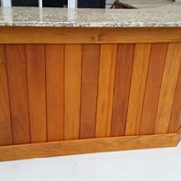 Hardwood Pool bar with a Granite countertop and Stained